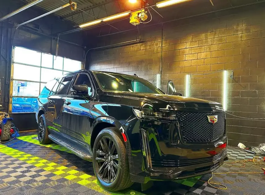 Black Cadillac Escalade under the shop lights at Pro-Tint