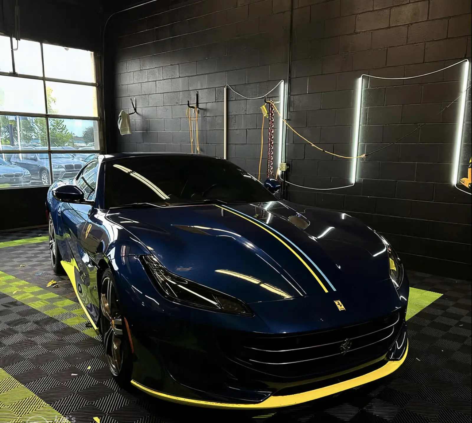 Blue Ferrari with a yellow stripe in the Pro-Tint bay