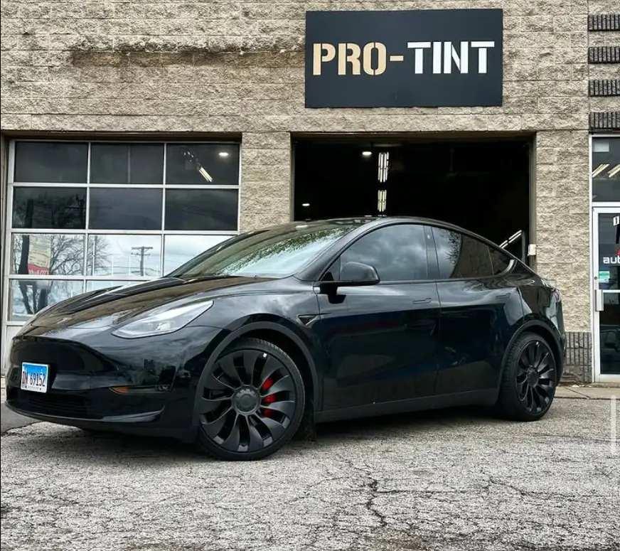 Black Tesla Model Y with tinted windows outside Pro-Tint